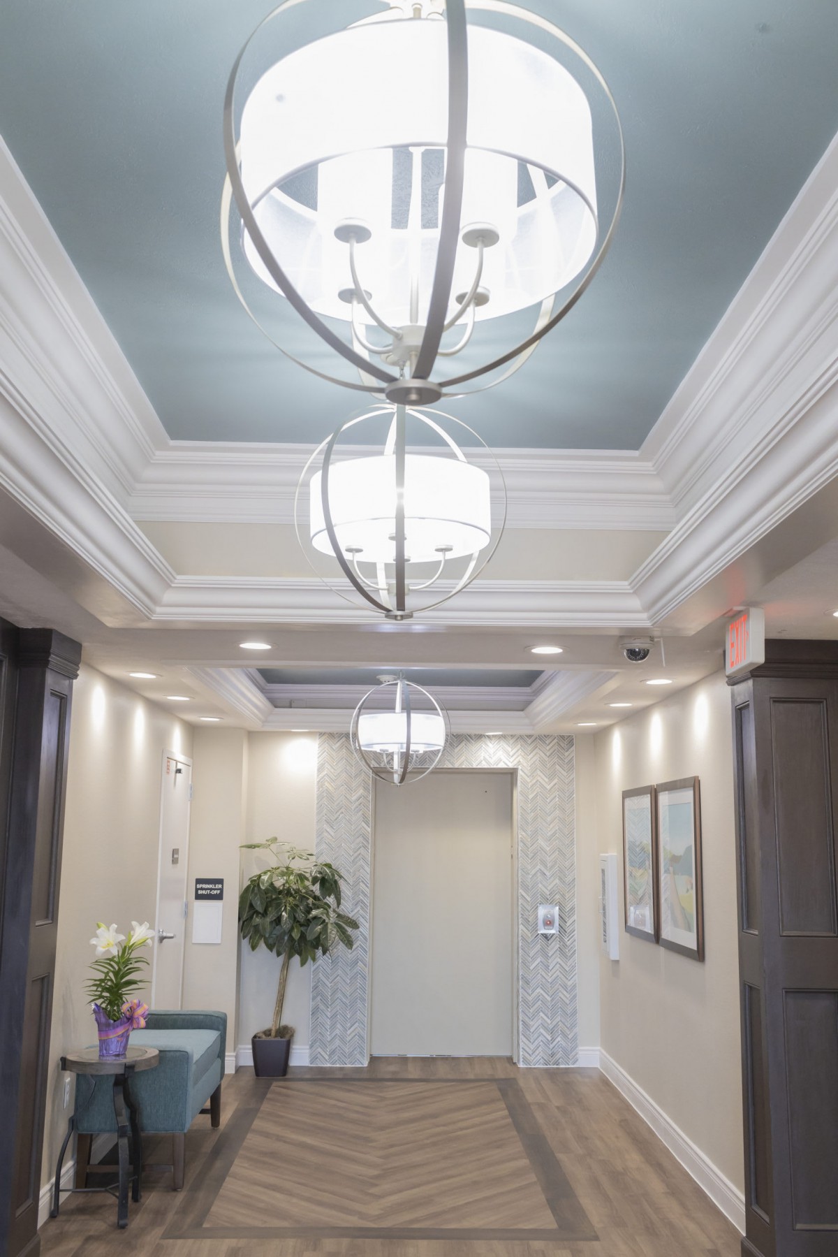 A modern hallway with elegant lighting and elevator access.