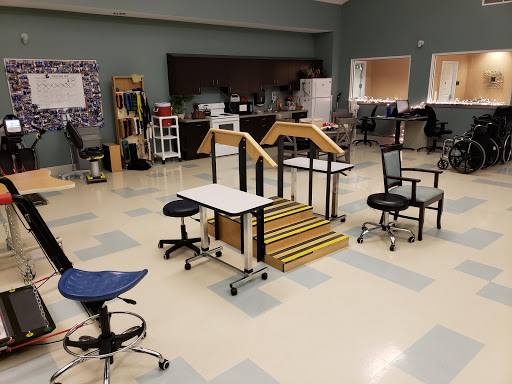 An organized classroom setting featuring various types of furniture including chairs and desks, along with a set of stairs for educational activities.