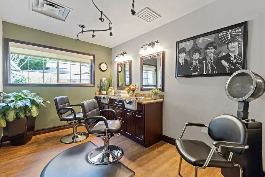 A cozy beauty salon interior with styling chairs and mirrors.