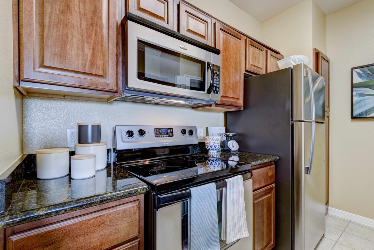 Modern kitchen with stainless steel appliances and wooden cabinets.