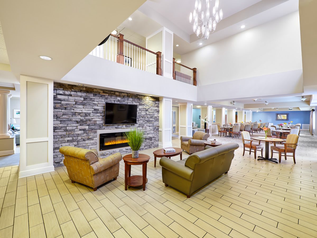 A spacious and modern lobby with comfortable seating and a fireplace.
