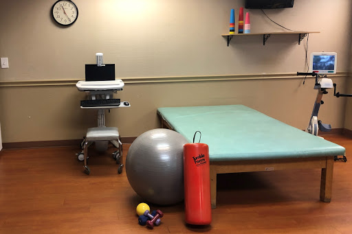 A physical therapy room equipped with various rehabilitation tools.