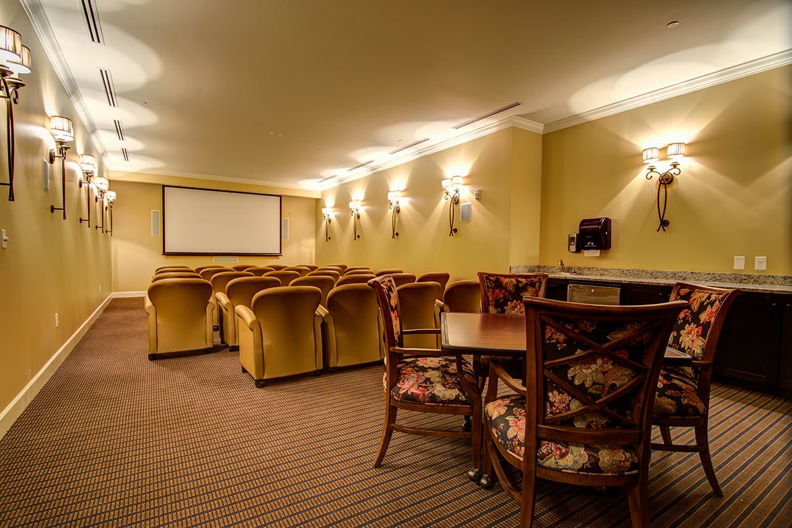 A cozy home theater with comfortable seating and a large screen.