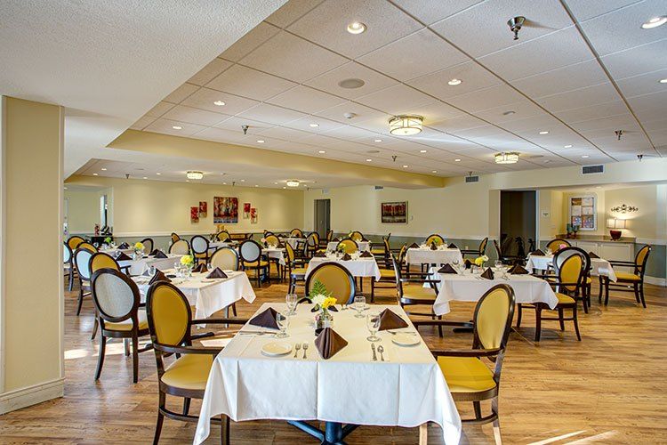 An elegant dining area featuring neatly arranged tables and chairs, ready for guests.