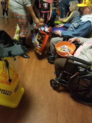 Residents at a care facility enjoying a Halloween candy distribution.