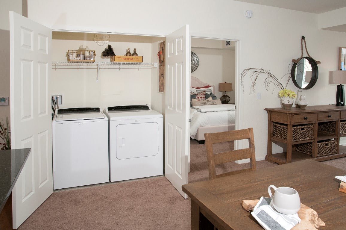 A cozy home interior featuring a laundry area with washer and dryer, adjacent to a dining space.