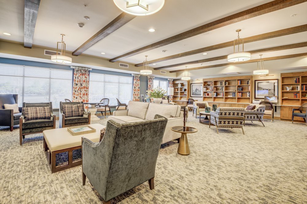 A spacious and well-lit lounge area featuring comfortable seating arrangements and stylish decor.