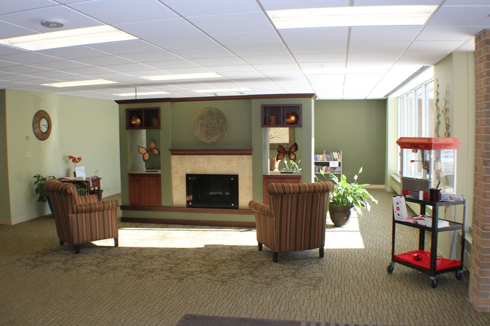 A cozy office waiting area with comfortable chairs and a fireplace.