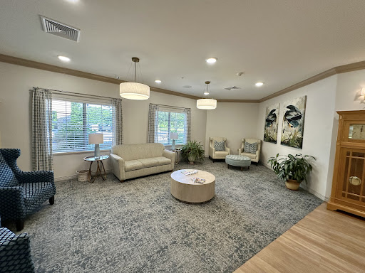 A modern and cozy lounge area featuring comfortable seating and natural light.