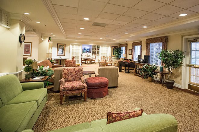 A spacious living room with comfortable seating and elegant decor.