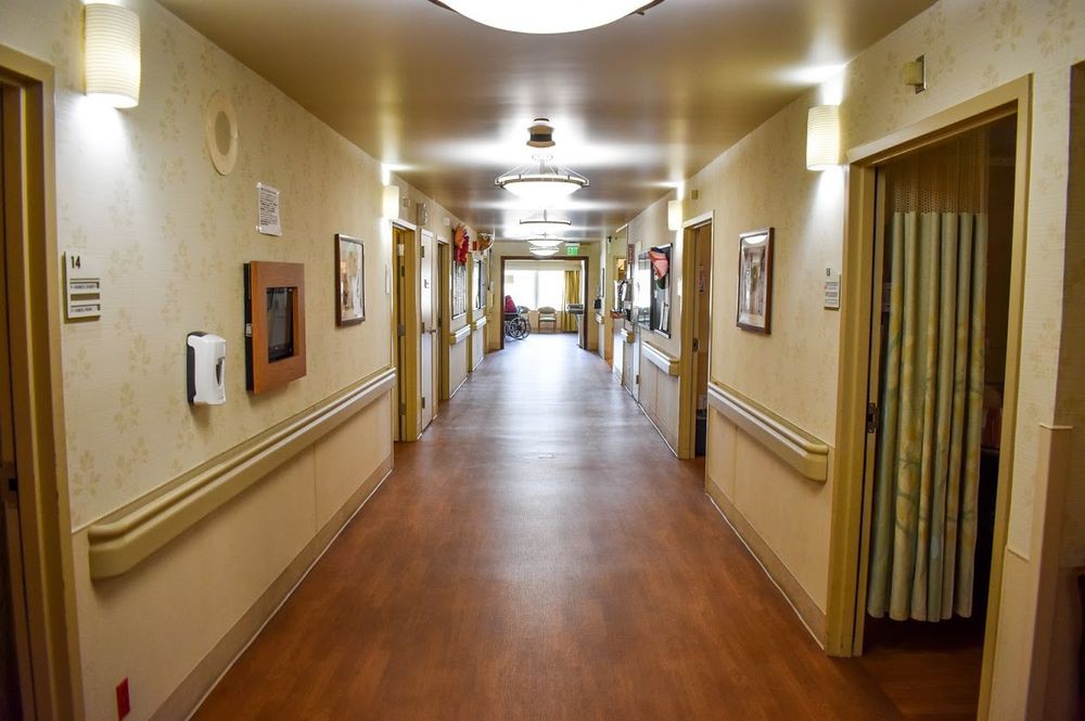 An empty hospital corridor with bright lighting and clean surroundings.