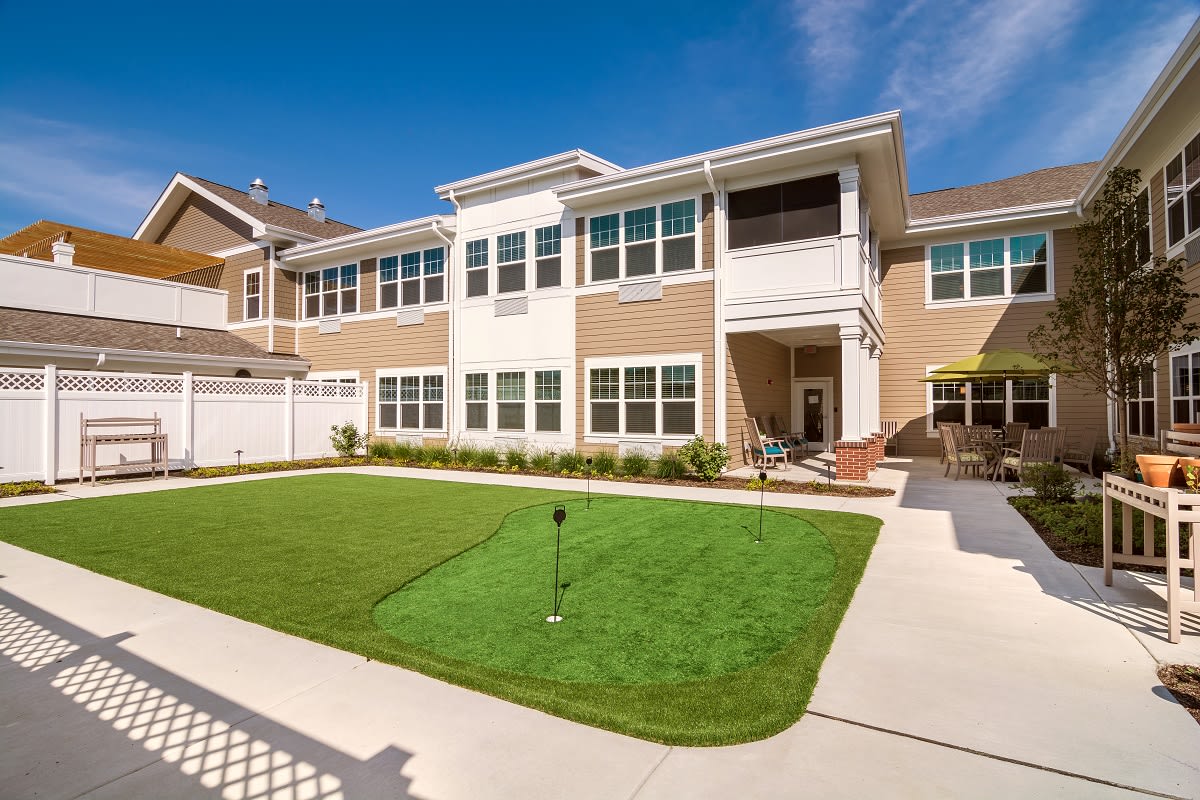 A residential building with a well-maintained lawn on a sunny day.