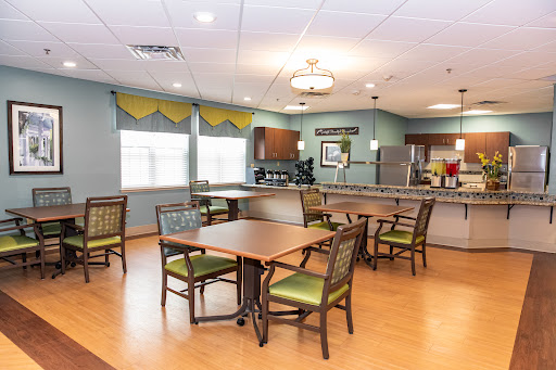 A warm and inviting dining area featuring modern furniture and a well-equipped kitchen.