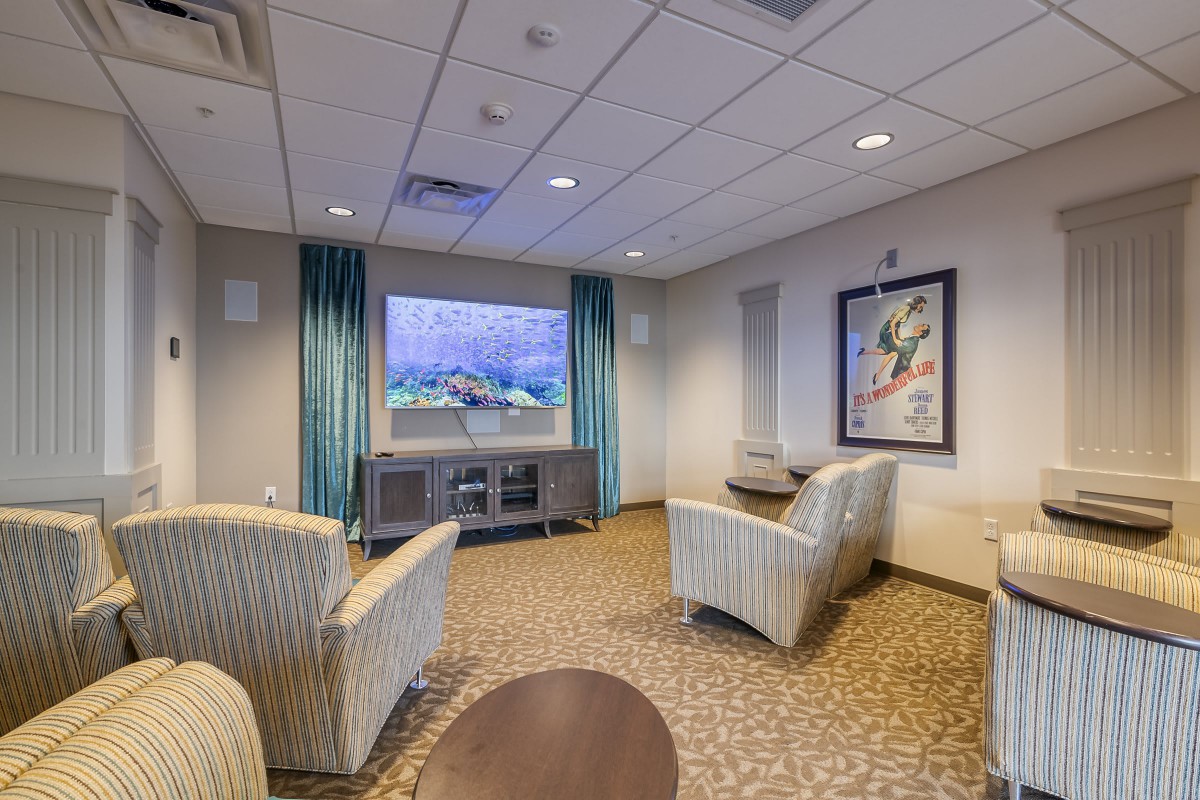 A cozy living room with comfortable seating and a large television.