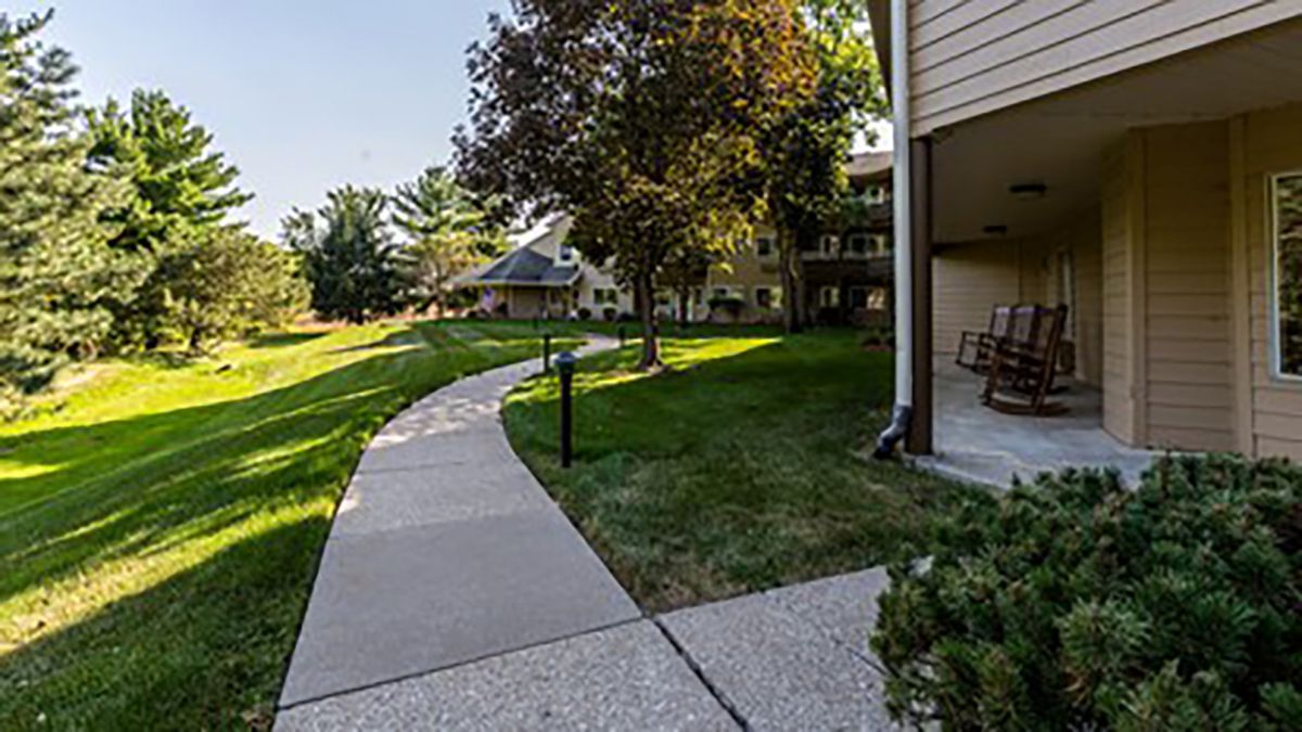 A peaceful pathway surrounded by greenery at an apartment complex.