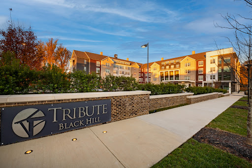 The Tribute at Black Hills, a modern residential complex showcasing beautiful architecture and landscaping.