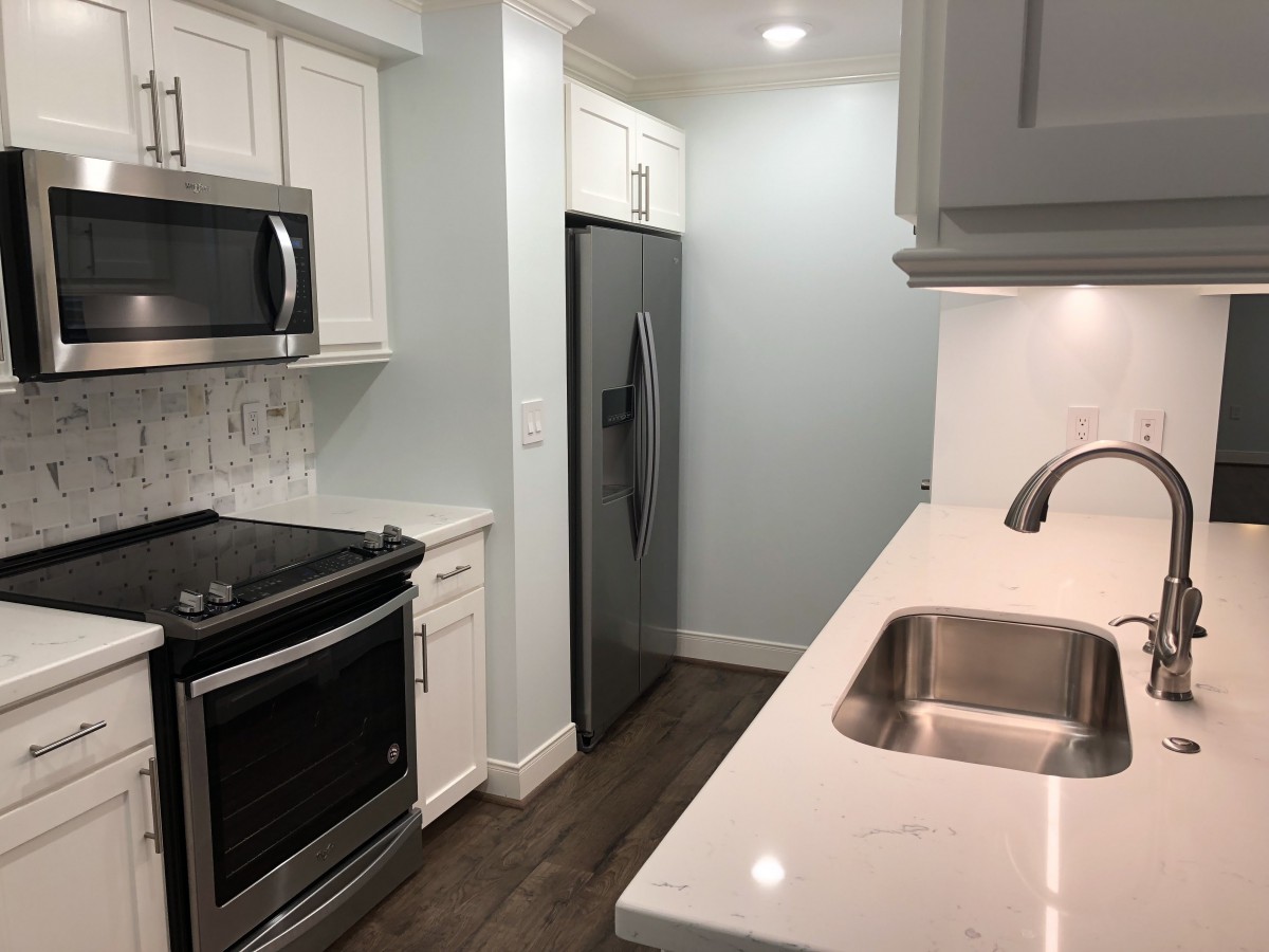 A modern kitchen with stainless steel appliances and sleek countertops.