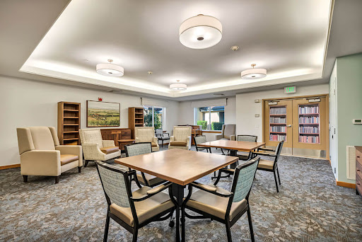 A cozy reading and gathering space featuring comfortable seating and ample lighting.