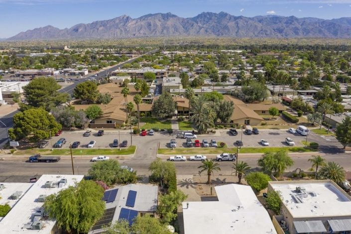 Aerial view of a suburban neighborhood with mountains in the background.