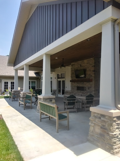 A spacious outdoor patio area featuring comfortable seating and elegant columns.