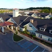 Aerial view of a suburban building complex with a parking lot.