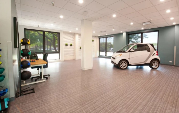 A modern, spacious office interior with a car inside.