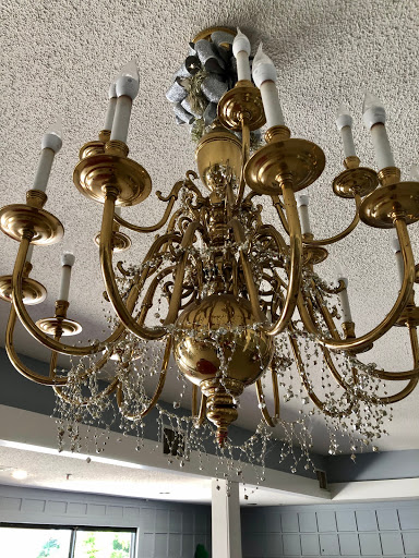 A beautifully ornate gold chandelier adorned with crystals, adding elegance to the room.