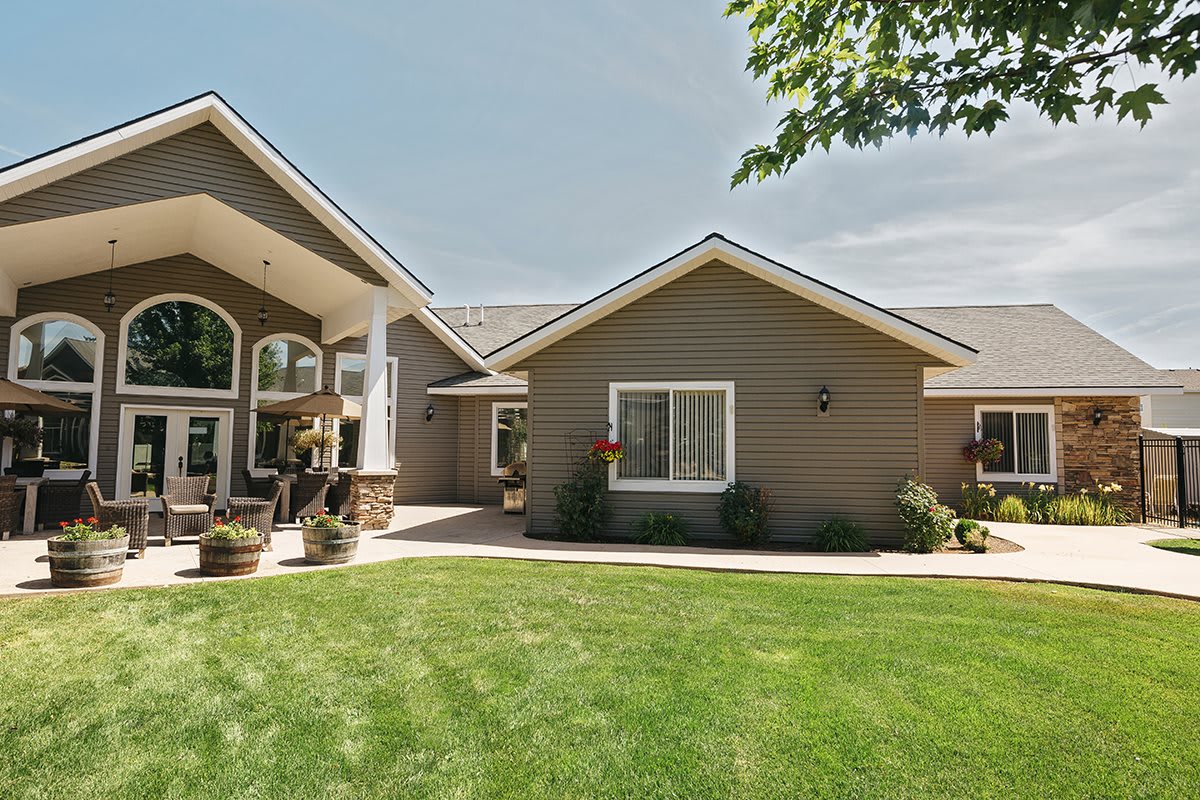 Exterior view of a suburban house with a well-maintained lawn.
