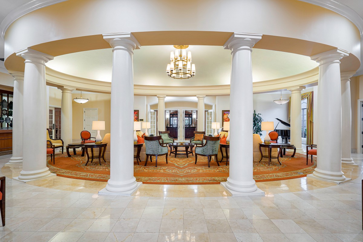 Luxurious hotel lobby with elegant columns and cozy seating area.