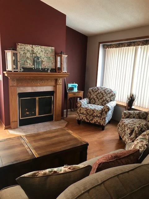 Cozy living room with a fireplace and patterned armchairs.