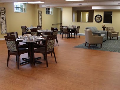 A cozy dining area featuring wooden tables and chairs, designed for a comfortable eating experience.