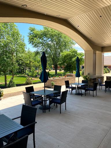 A serene outdoor dining area with a beautiful view of greenery, perfect for enjoying meals in the sun.
