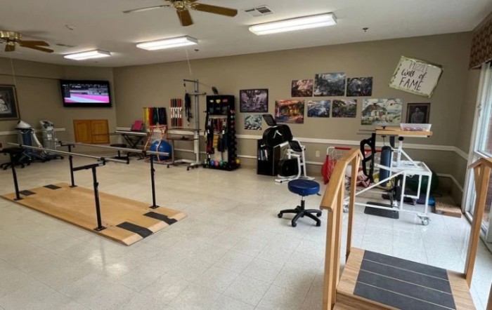 A physical therapy room equipped with various rehabilitation tools and exercise equipment.
