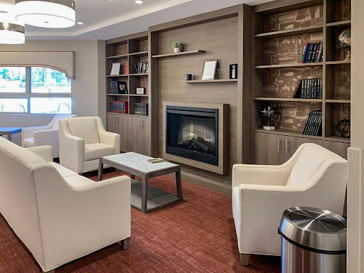 A cozy living room setup featuring a modern fireplace and comfortable seating.