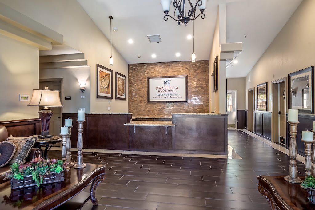 A modern office reception area with stylish decor, featuring wooden floors and artwork on the walls.