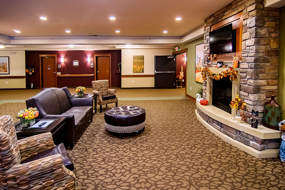 A cozy hotel lobby with comfortable seating and a decorative fireplace.