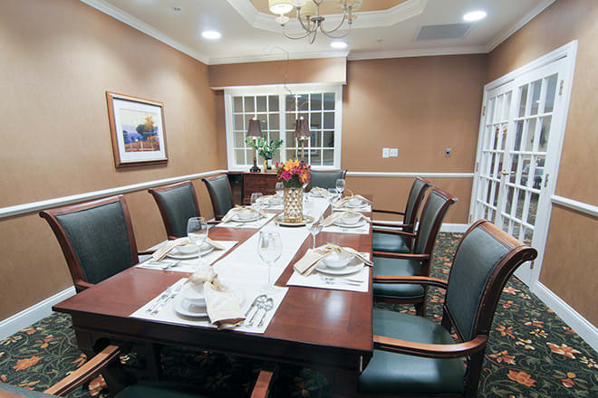 A well-appointed dining or conference room with an elegant table setting and comfortable chairs.
