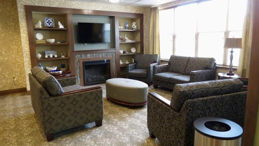 A cozy living room setup featuring comfortable seating, a television, and a fireplace.