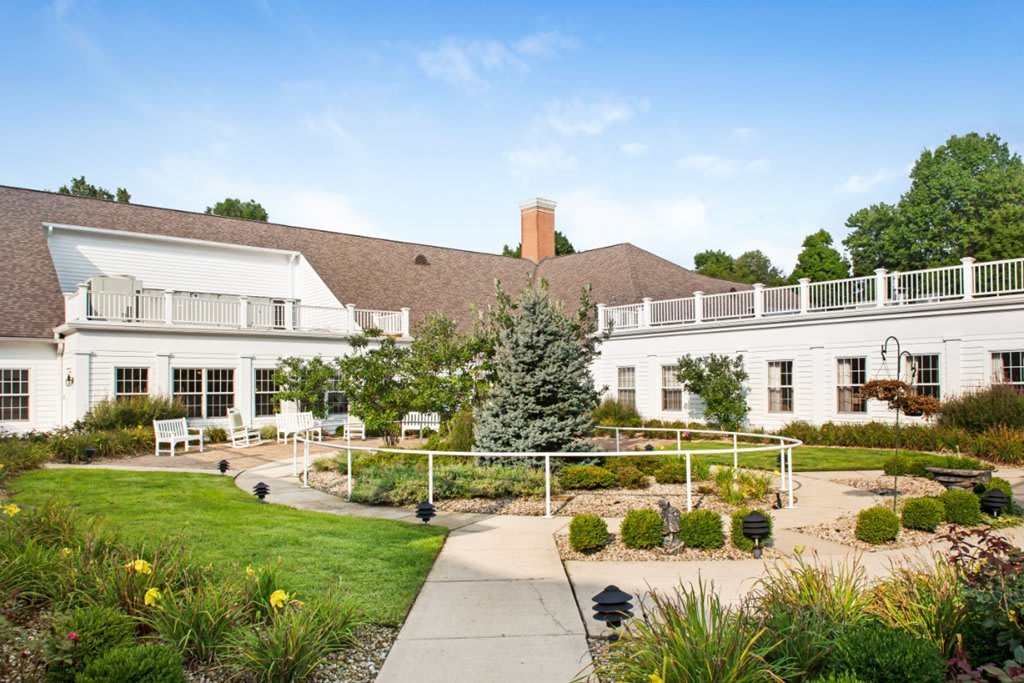A beautifully landscaped garden in front of a large building.