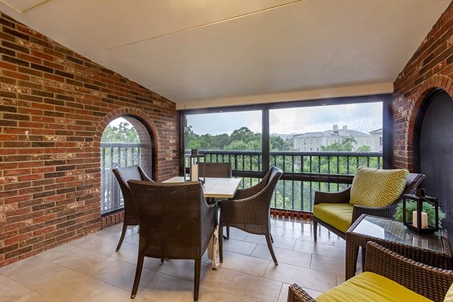 A cozy balcony with modern patio furniture and a scenic view.