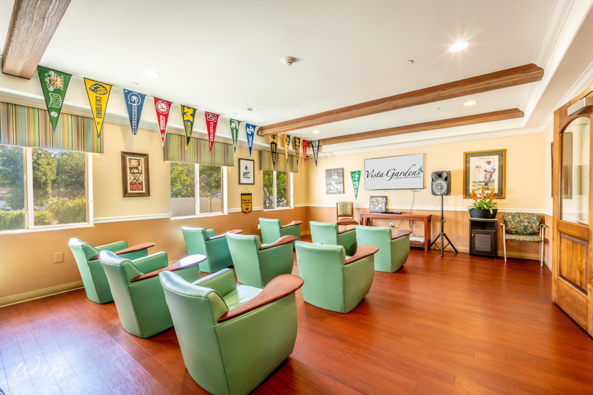 A cozy meeting room with comfortable chairs and colorful pennants hanging from the walls.