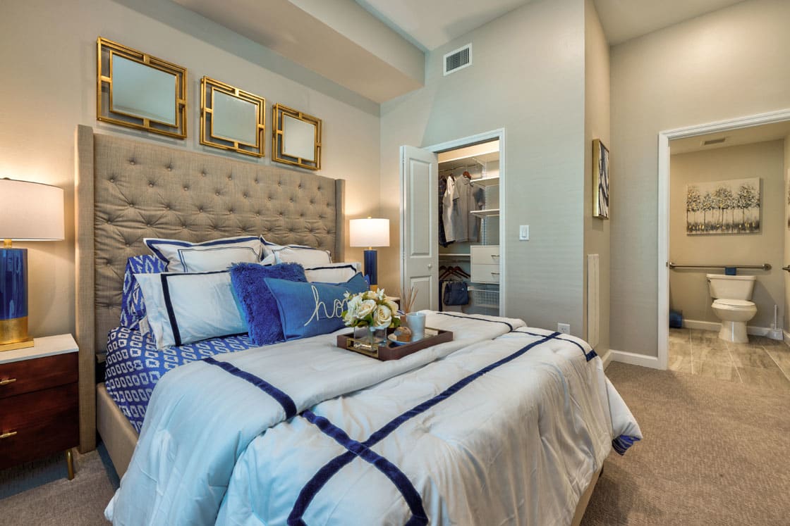 A luxurious modern bedroom with elegant decor and a comfortable bed.