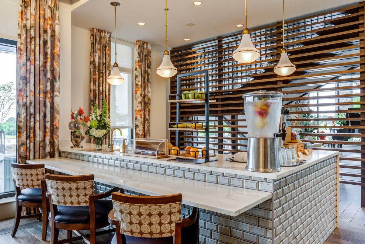 A modern bar interior with stylish seating and pendant lighting.