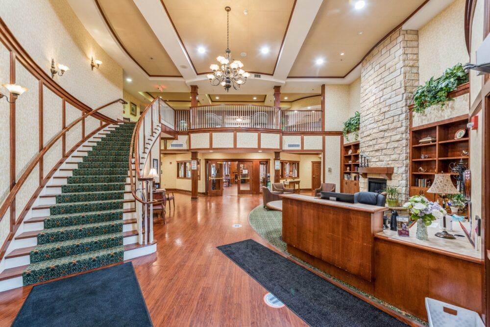 Elegant hotel lobby with a grand staircase and warm lighting.