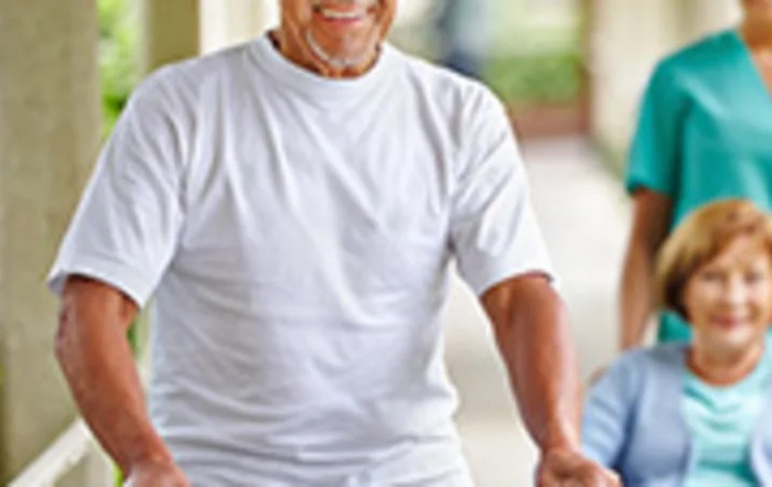 An elderly person walking outdoors.