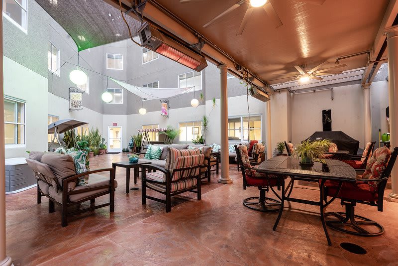 A cozy outdoor patio with comfortable seating and ambient lighting.