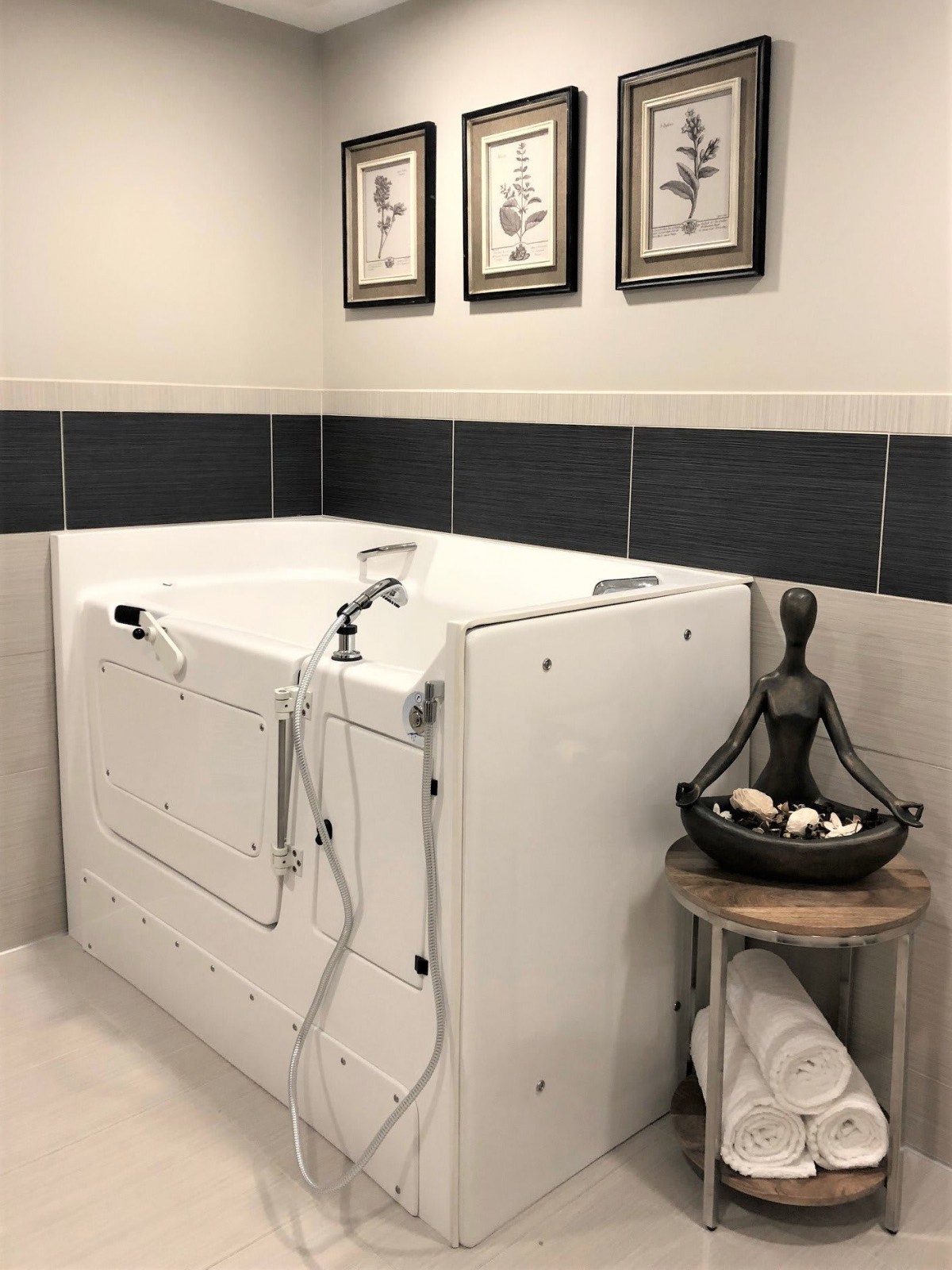 A modern bathroom featuring a walk-in bathtub with artistic decor.