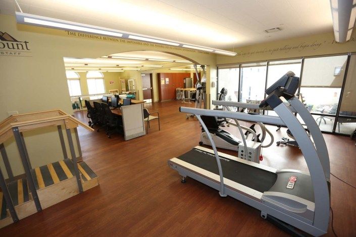 A spacious gym area featuring exercise equipment including treadmills and other fitness machines.