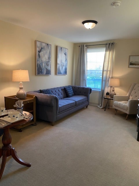 A cozy living room with a blue sofa, armchair, and soft lighting from lamps.