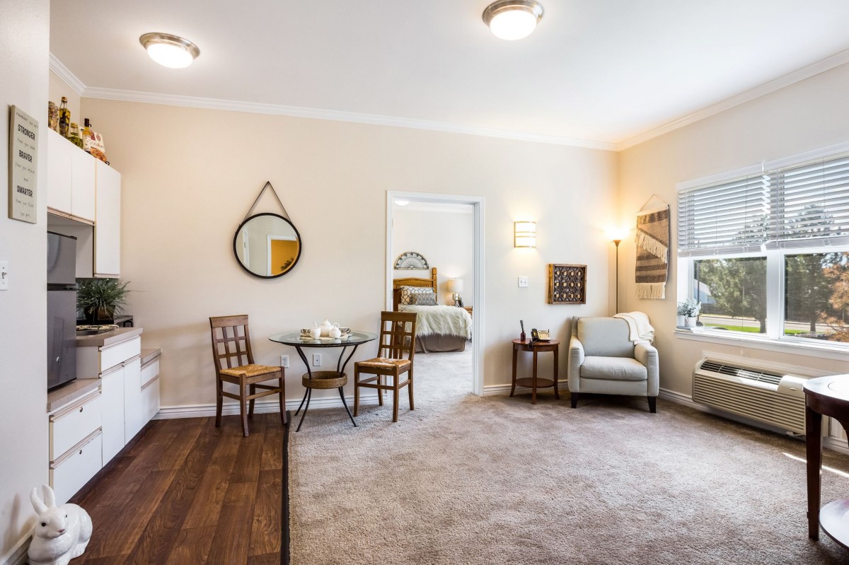 A cozy living room with comfortable seating, decorative elements, and warm lighting.